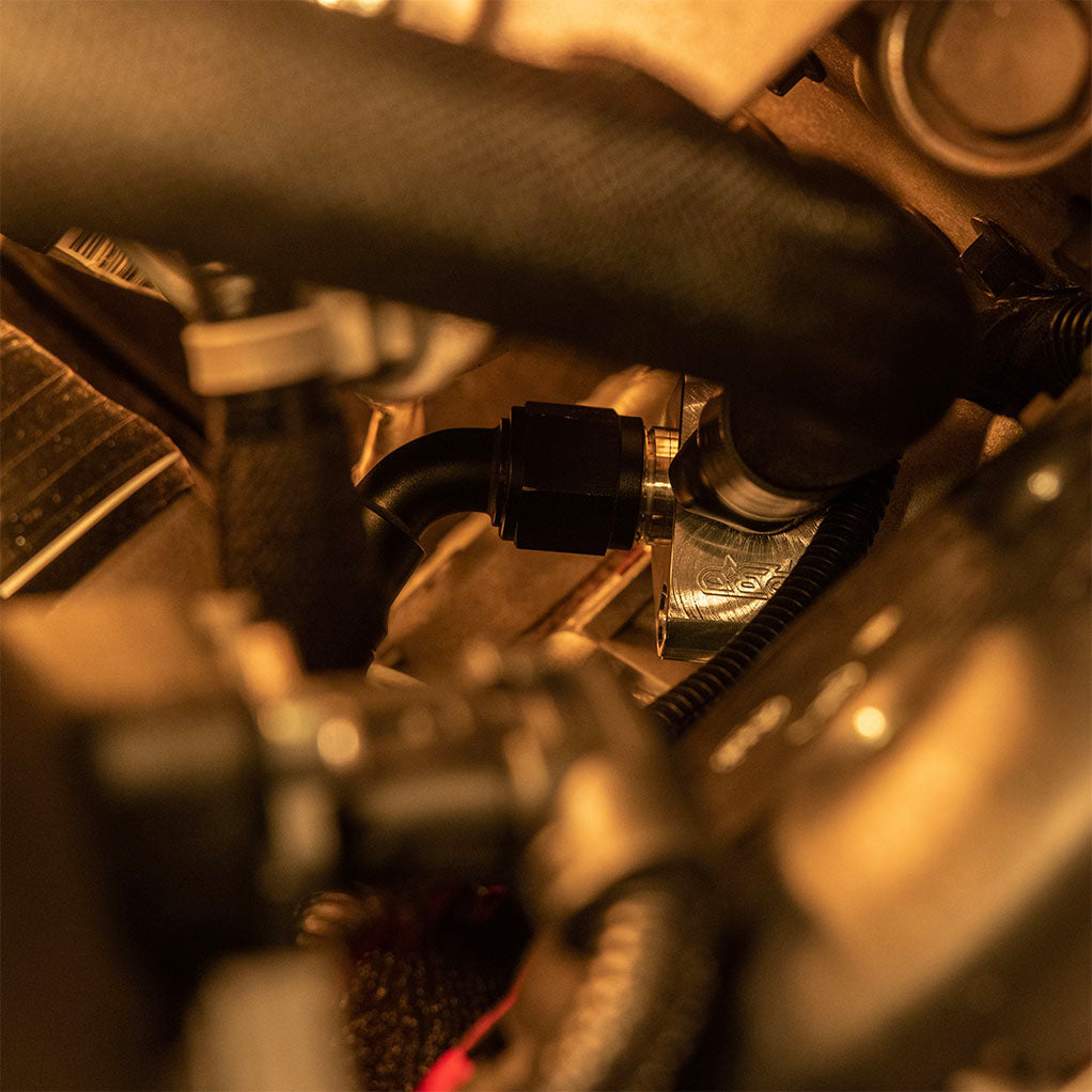 5th gen cummins billet coolant riser installed with spin on fittings and hose connectors