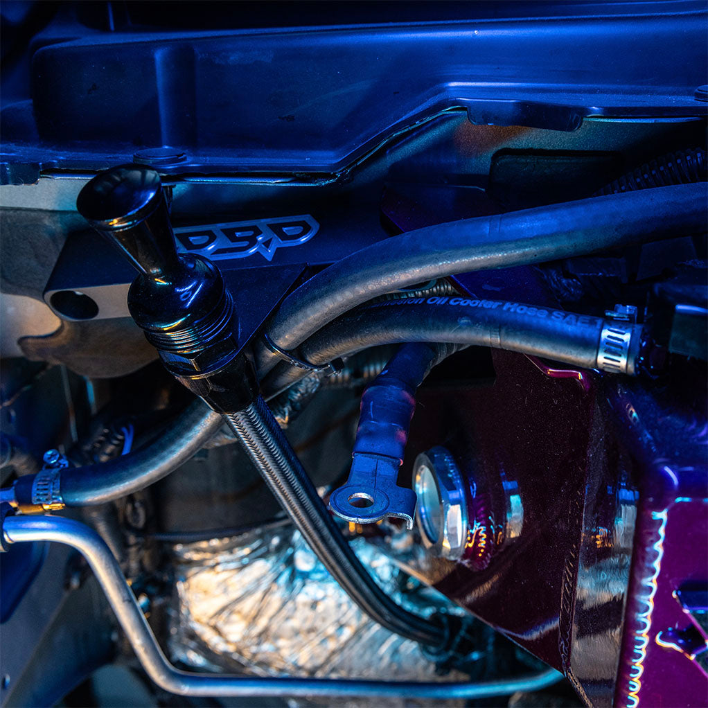 68rfe Remote dipstick bracket installed on truck with view of coolant tank on side