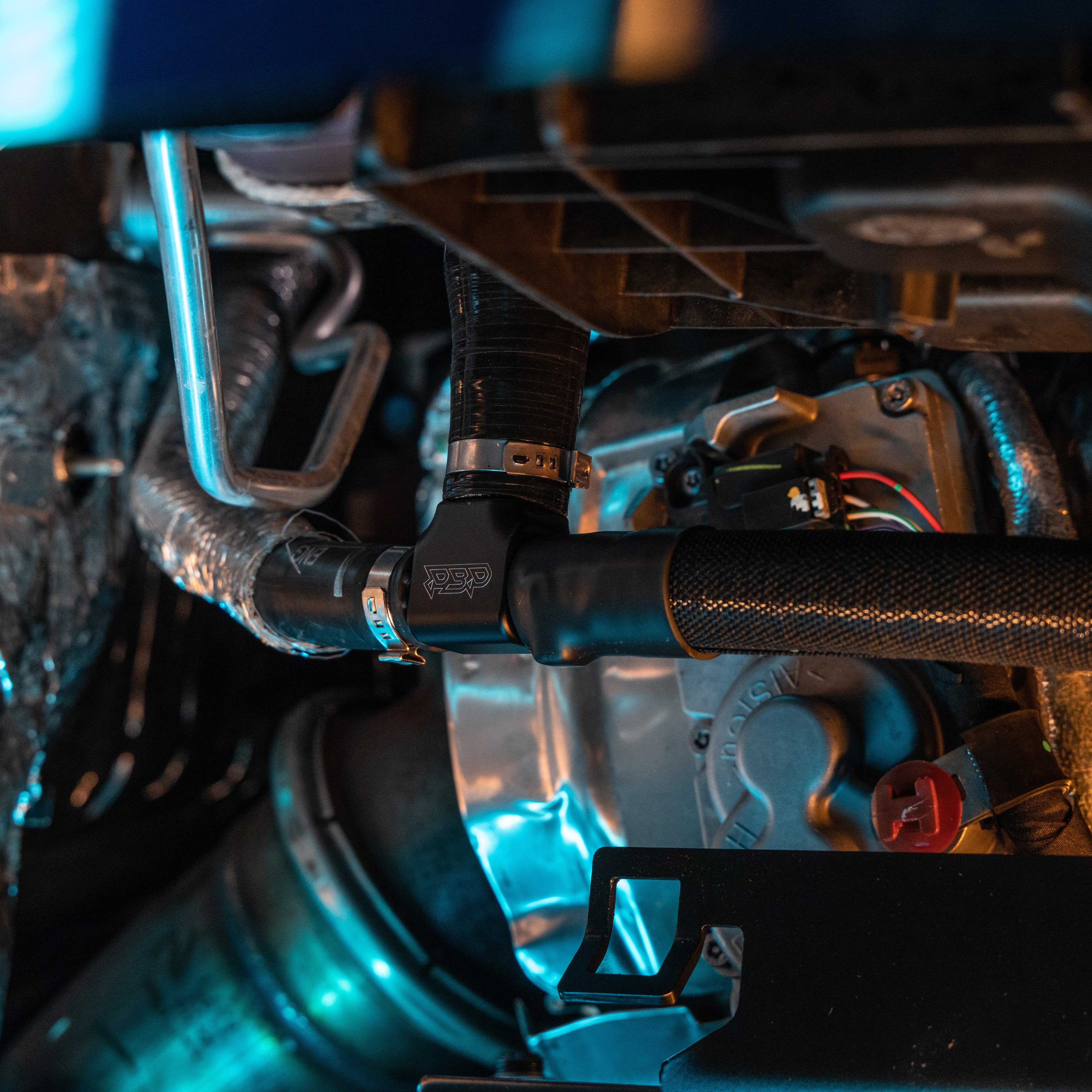 Billet coolant tee installed with hoses attached