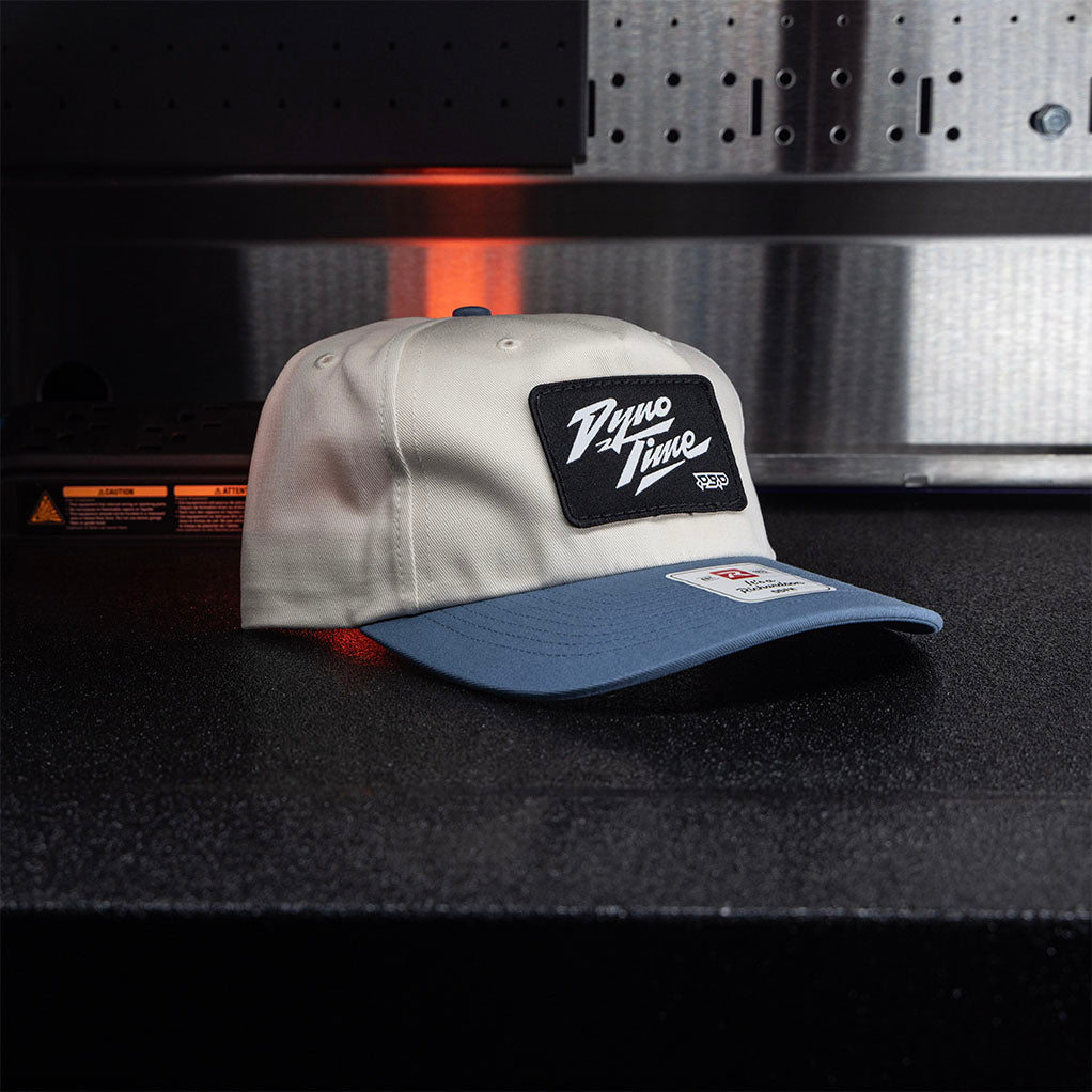 Cream and blue adjustable snapback 5 panel patch hat. 