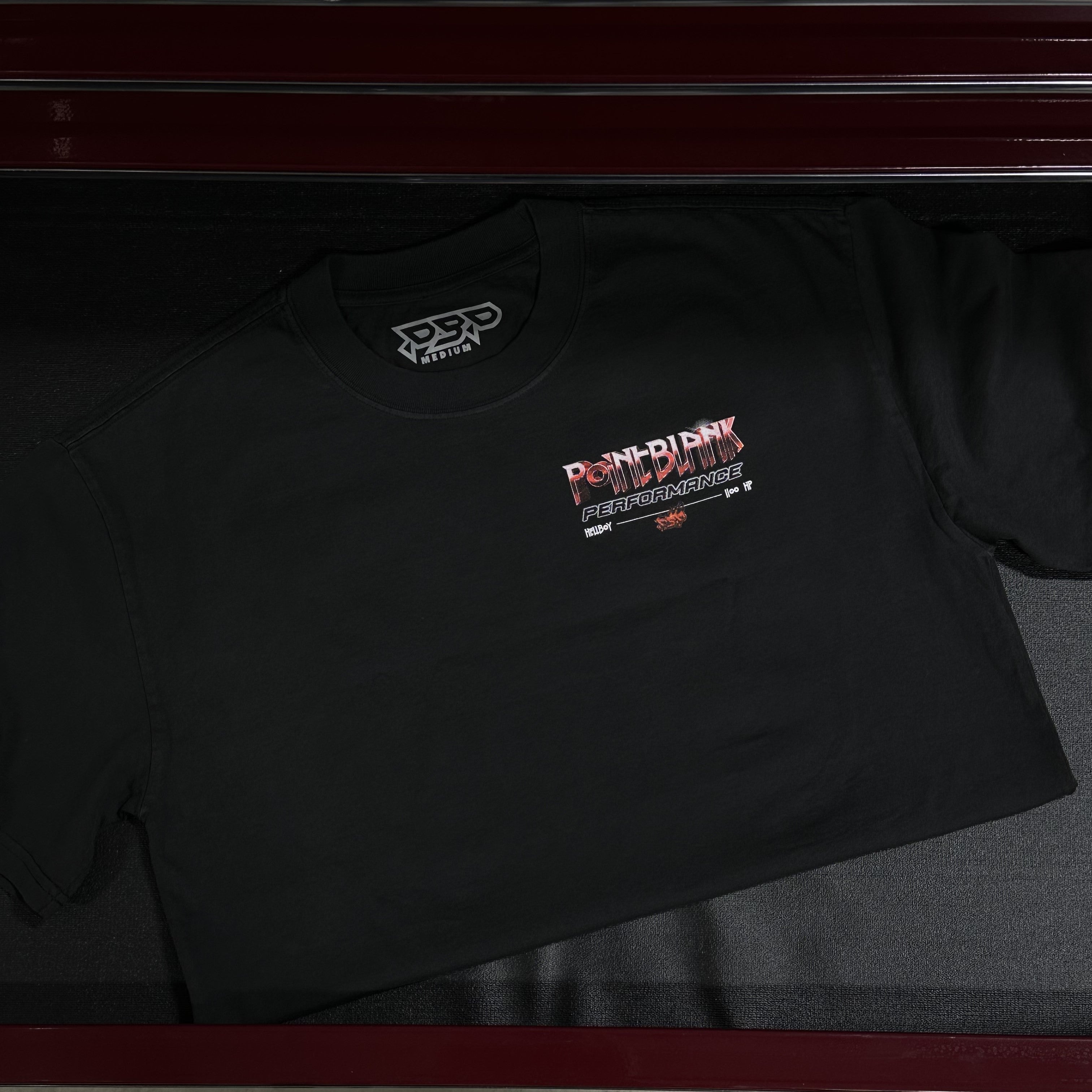 Hellboy graphic tee front side faded black. Left pocket graphic